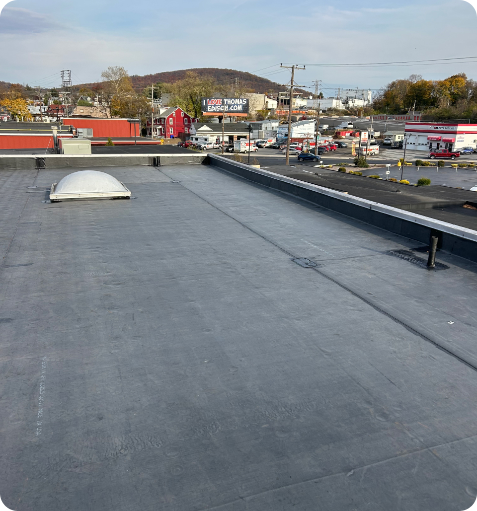 J&L Roofing crew on a commercial flat roof