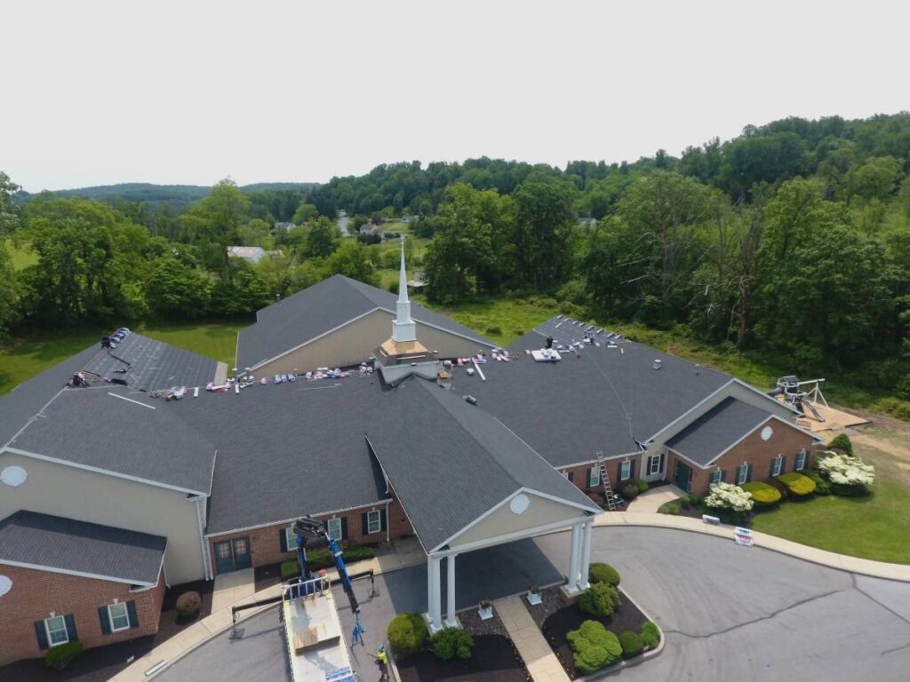 Worker on roof replacement project